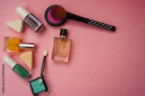 Fototapeta Naklejka Na Ścianę i Meble -    A set of cosmetics: blush, nail polish, shadows, brushes, lipstick, eau de toilette on a pink background. Girls' Accessories. Flat lay with place for text