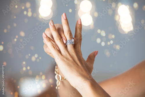 Closeup photo of a beautiful female hands with elegant manicure and diamond rings