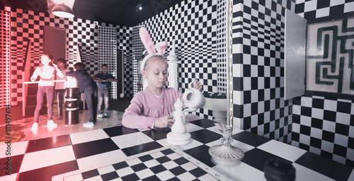 schoolchild play in chess quest room