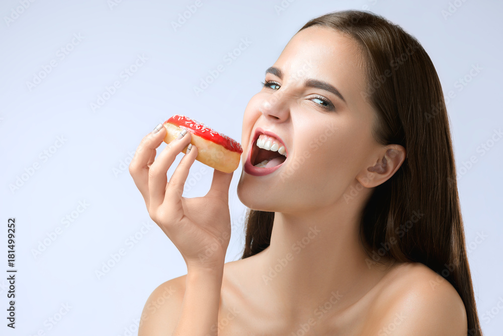 beautiful woman biting a donut