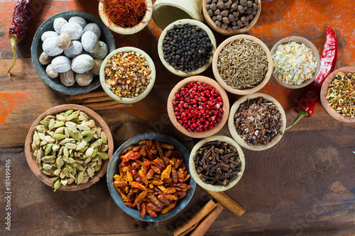 Fototapeta Naklejka Na Ścianę i Meble -  Variety of different asian and middle east spices, colorful assortment, on old wooden table