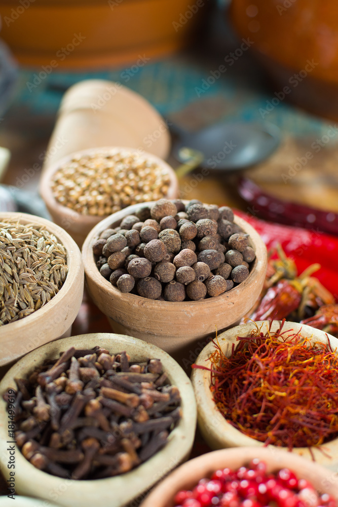 Variety of different asian and middle east spices, colorful assortment, on old wooden table