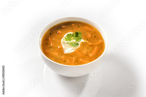 Cream Carrot Soup in a White Cup Garnished with Sour Cream