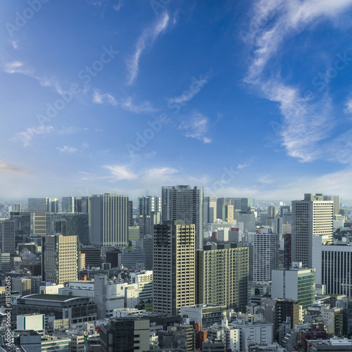 Aerial skyscraper view of office building and downtown and cityscapes of Tokyo city with blue sly and clouds background. Japan, Asia © lukyeee_nuttawut