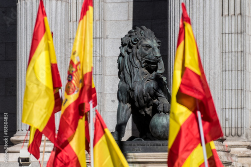 Sculpture of lion in the Congress of Deputies of Madrid with Spanish flags photo