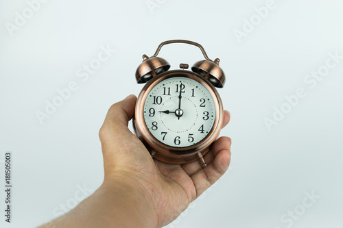 Hand holding alarm clock