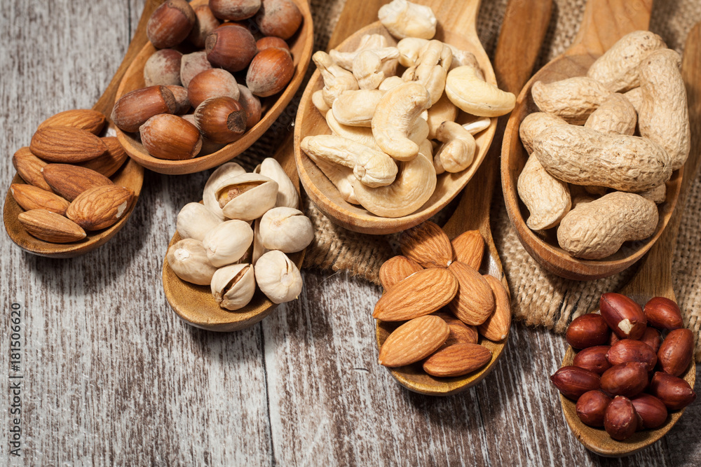 Healthy mix nuts on wooden background. Almonds, hazelnuts, cashews, peanuts, pistachios, brazilian nuts Healthy mix nuts on wooden background. Almonds, hazelnuts, cashews, peanuts, pistachios, brazilian nuts