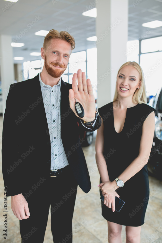 Happy owners of new electro vehicle in auto showroom. Man and woman choosing new vehicle. Happy owners of new electro vehicle in auto showroom. Man and woman choosing new vehicle.