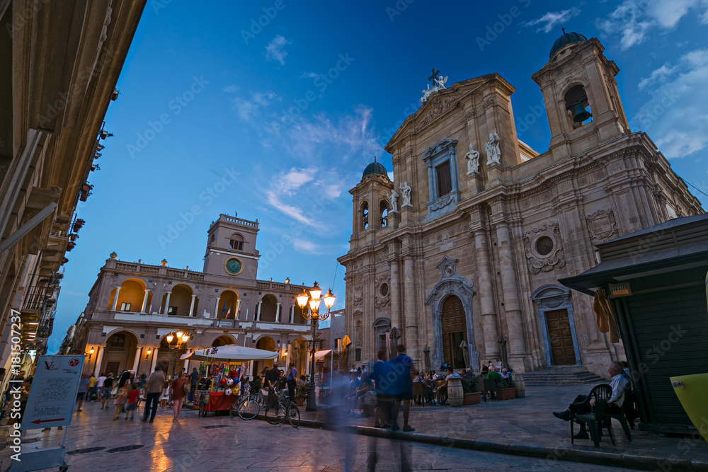 MARSALA, ITALY - CIRCA SEPTEMBER 2017: Time lapse, People walking in the warm evening in the Old Town Square. In Sicily