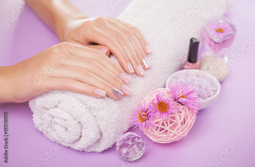 Beautiful pink and silver manicure with flowers and spa essentials