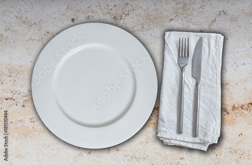 Empty plate and cutlery on marble