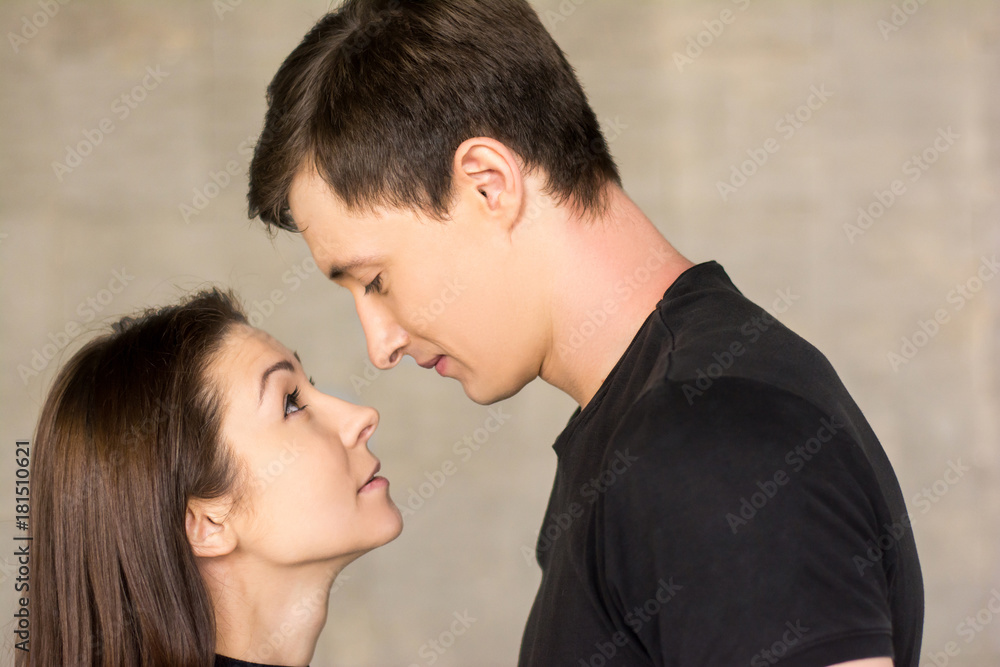 Portrait of couple looking at each other. Young loving guy and woman looking at each other with affection. Portrait of couple looking at each other. Young loving guy and woman looking at each other with affection.