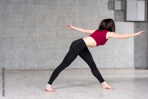 Slim woman doing sport exercise. Young slim dancer woman working out in studio. School of gymnastics and dance.