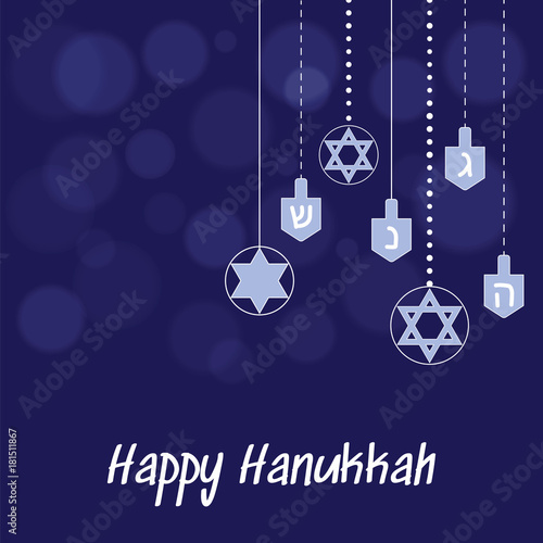 Hanukkah blue background with hanging star of David and dreidel and the blurred spots of light