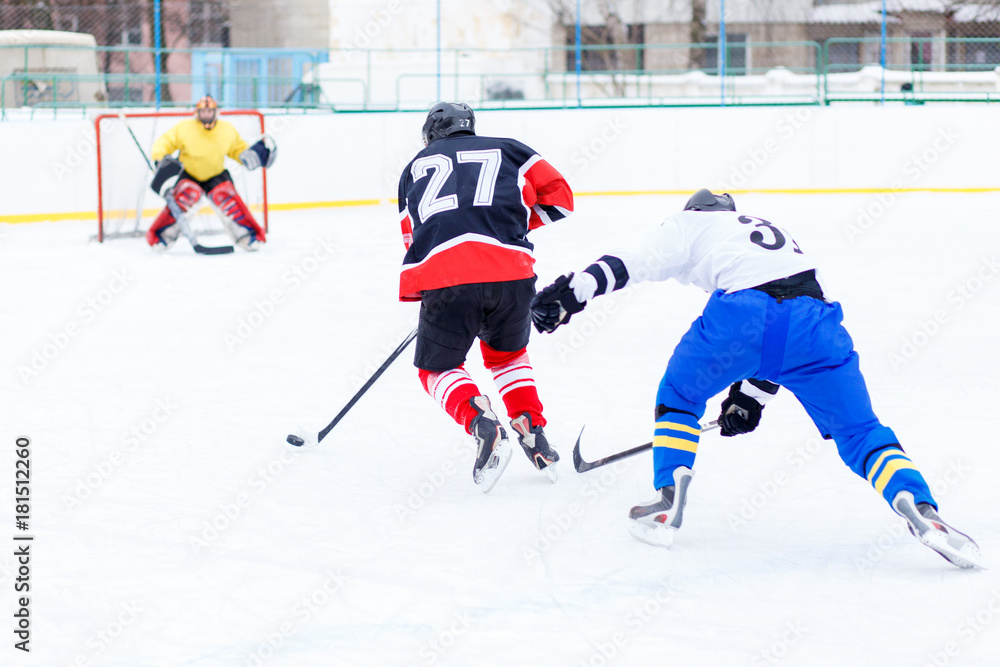 Fototapeta premium Young skater man in attack. Ice hockey game.