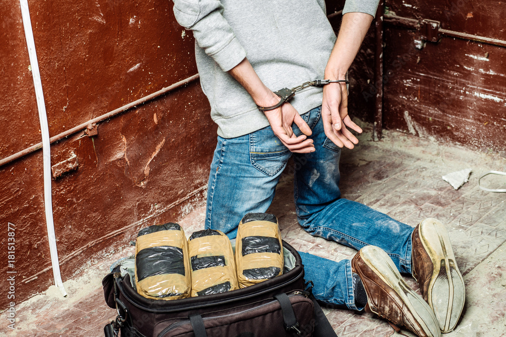 Police arrest drug trafficker with handcuffs. Police arrest drug trafficker with handcuffs.