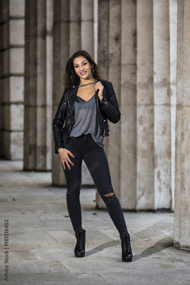 Young woman black jeans and leather jacket Stock-foto Adobe Stock