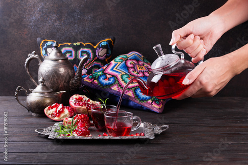 Fruit pomegranate tea in a teapot and cup