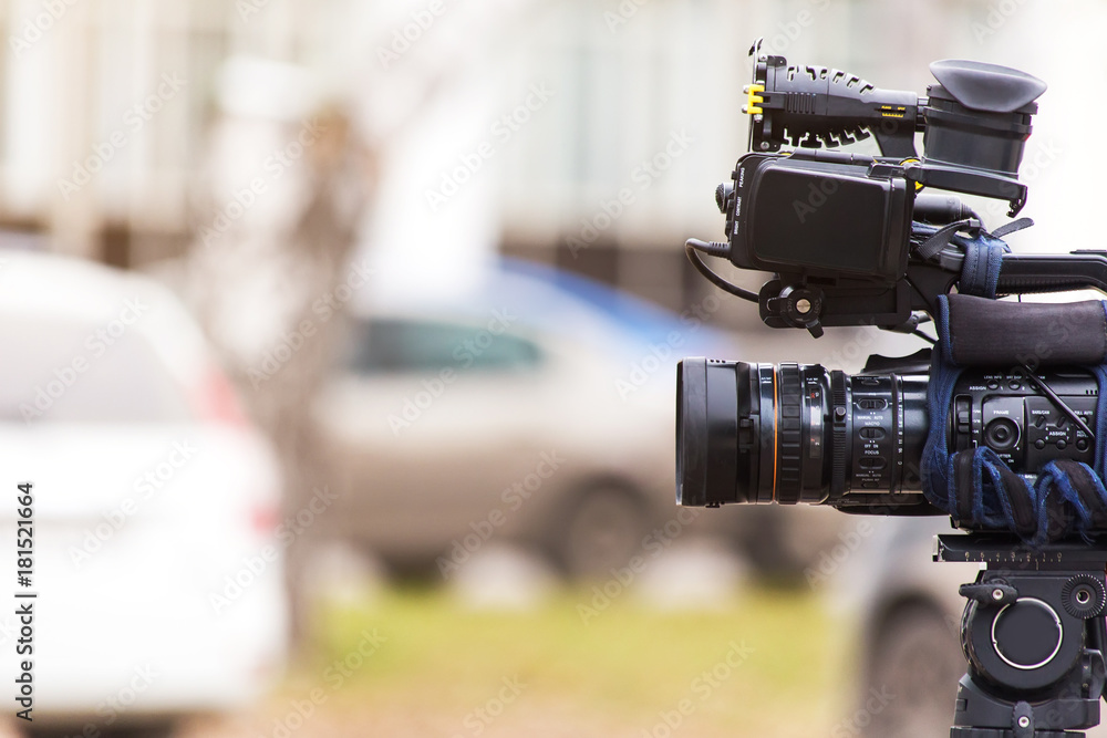 A professional video camera with a microphone on a tripod for shooting news  reports and news. Stock Photo | Adobe Stock