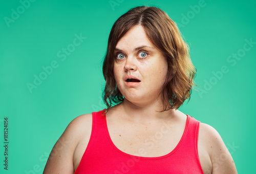 Woman on a green background, surprise, diet, fat