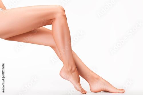 Woman legs on white background.