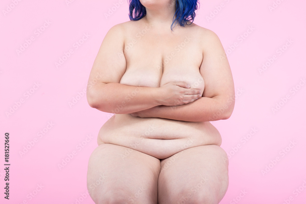 Plus size model in front of pink background Plus size model in front of pink background