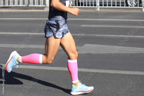 Marathon runner running on city road