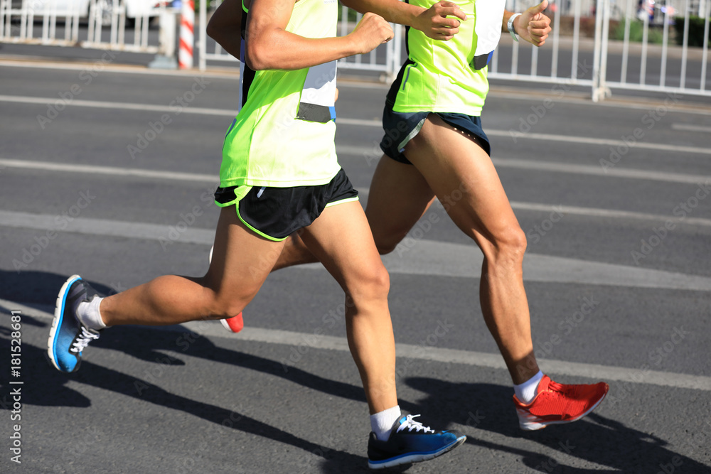 Fototapeta premium Marathon runners running on city road