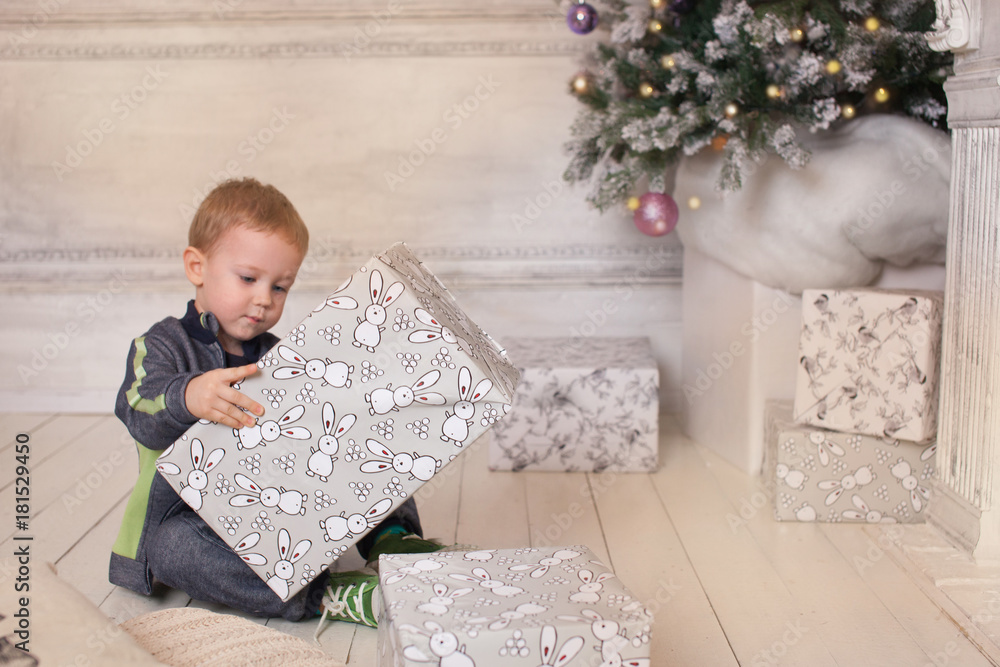 Naklejka premium Boy, Christmas atmosphere at home, Christmas tree