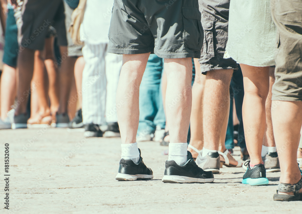 People standing in a queue on the street. People standing in a queue on the street.