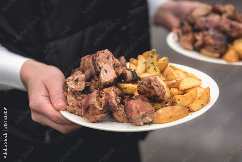 Fototapeta premium Anonymous person takes fried meat and potato