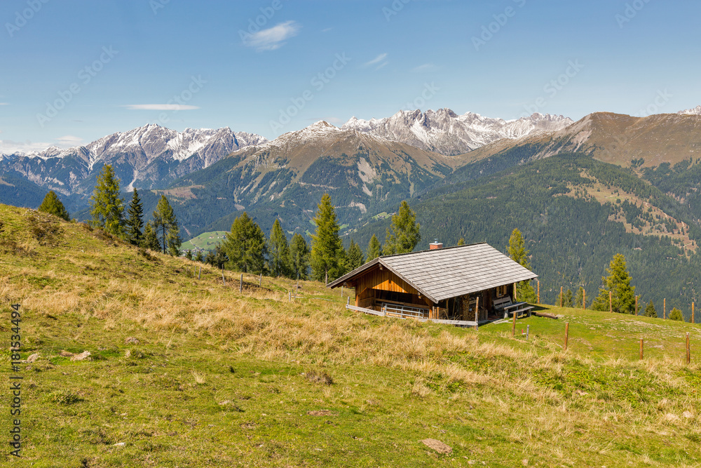 Plakat Wooden shepherd lodge with Alpine mountain landscape in Austria.