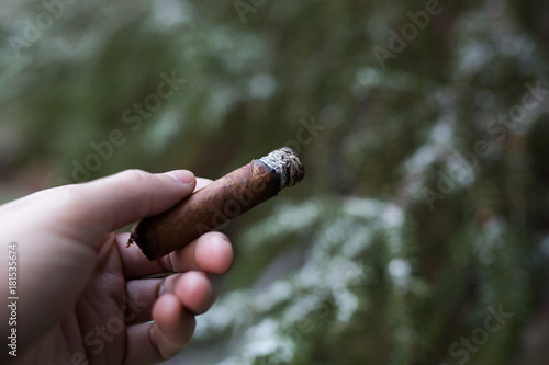 Smoking a cigar in the snow forest