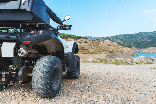 A man is driving ATV on off-road.