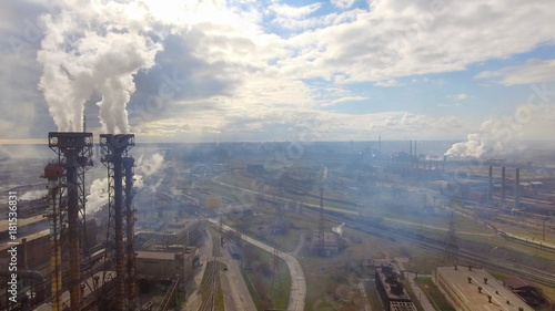 Aerial view of industrial steel plant. Aerial sleel factory. Flying over smoke steel plant pipes. Environmental pollution. Smoke.