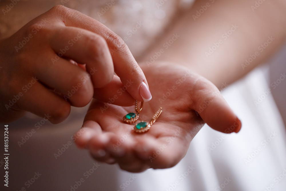 Bride keeps earrings with green precious stones Bride keeps earrings with green precious stones