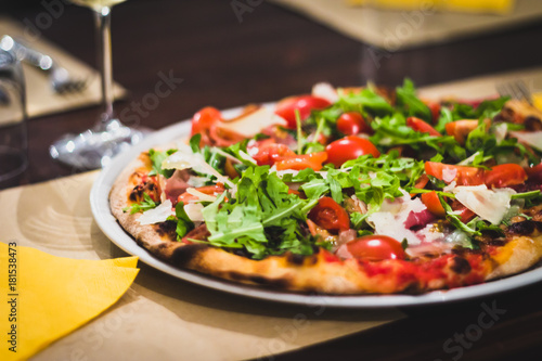 Real italian pizza with fresh tomato and rucola