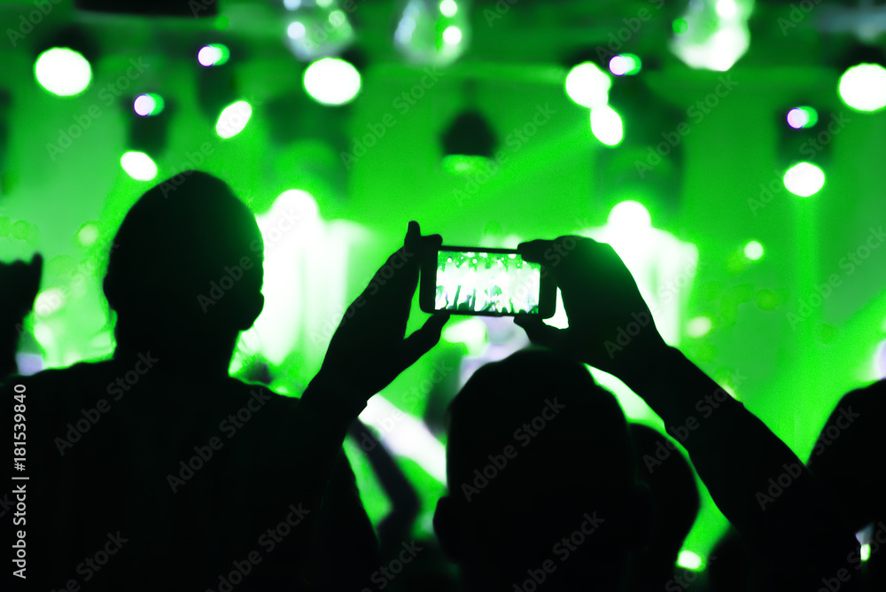 Video recording of the concert on the smartphone phone of the Beach or club party. Сonceptual background of the youth party. blurred.