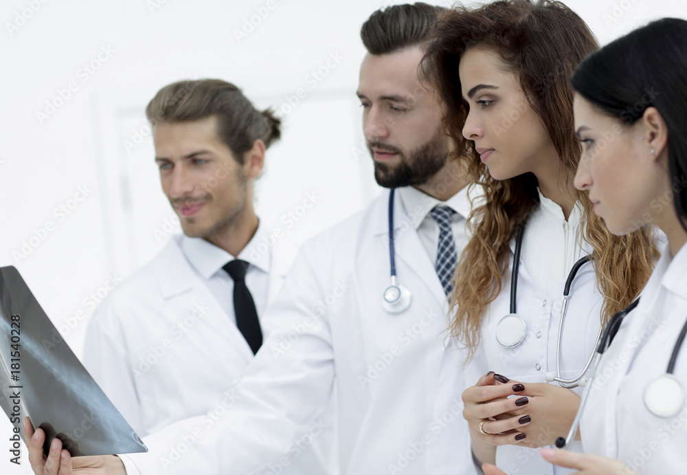 Fototapeta premium Portrait of young male doctors looking at x-ray