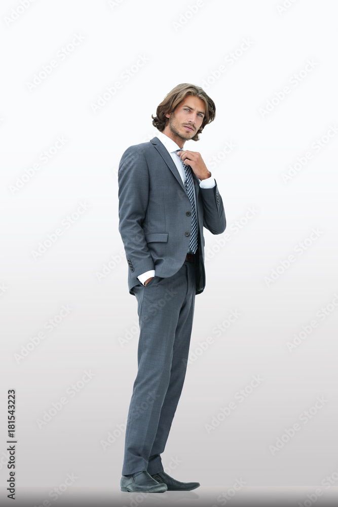 businessman straightening his tie isolated on a white background
