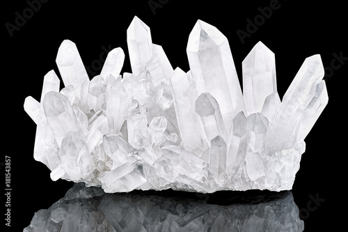 Pure Quartz Crystal cluster isolated on black background. Natural translucent crystal stone surface macro closeup. Macro of beautiful rare mineral stone