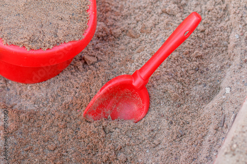 red pail and scoop in the sandbox