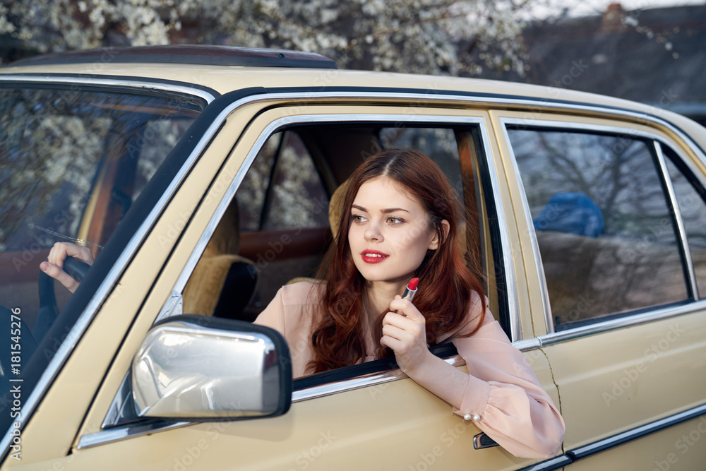 Woman driving a car, a car, a woman peeking out of a car window, a woman with a lipstick