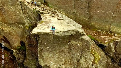 Trolltunga. Norway. girl sitting on the edge of the Trolltunga. aerial vie. beautiful landscape of Norway