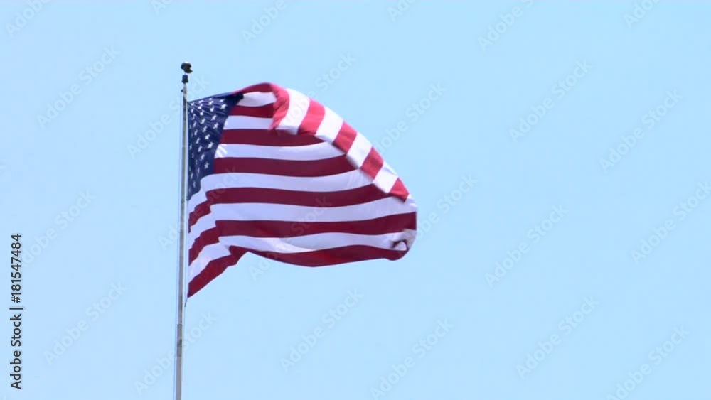 Low angle, American flag blows in wind Low angle, American flag blows in wind