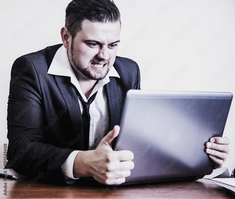 I hate my office work. Young businessman working with documents. (Low  wages, overtime working hours, lack of career prospects, unfreedom)  Stock-Foto | Adobe Stock