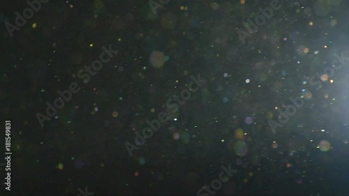 Close up, dust particles float near film projector