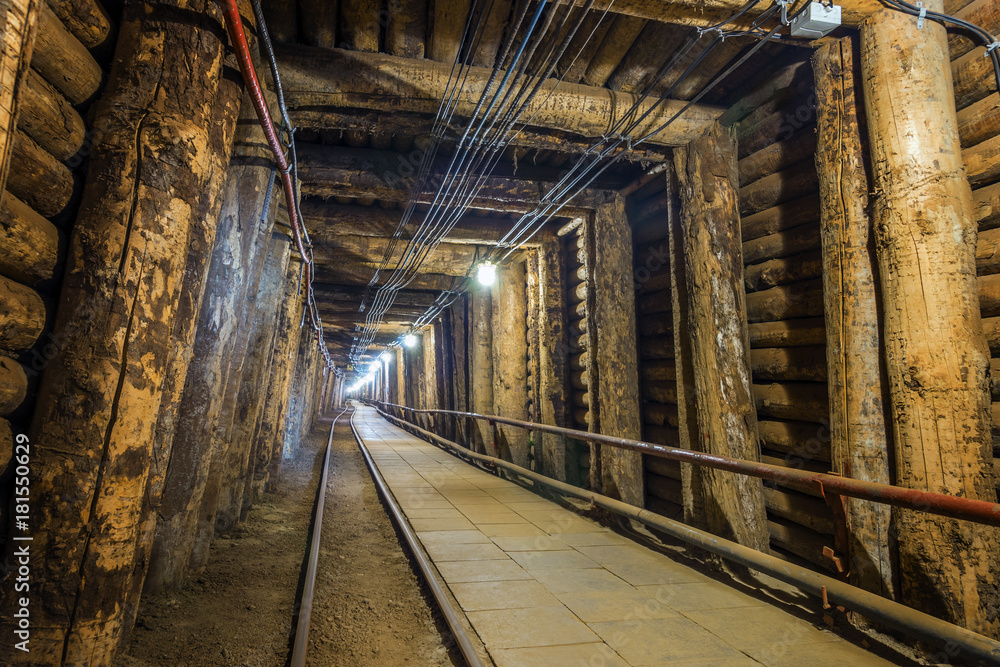 Illuminated underground tunnel in old mine Illuminated underground tunnel in old mine