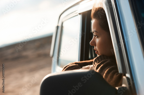 Woman looking out the window of her car photo