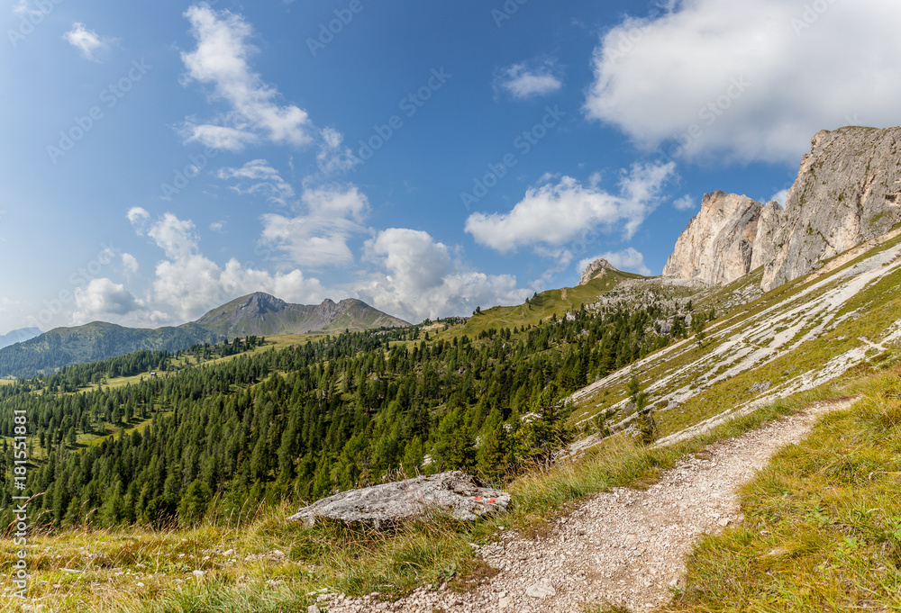 Path at the foots of Mount Settsass with volcanic Mount Col di Lana background, Valparola Pass, Dolomites, Italy